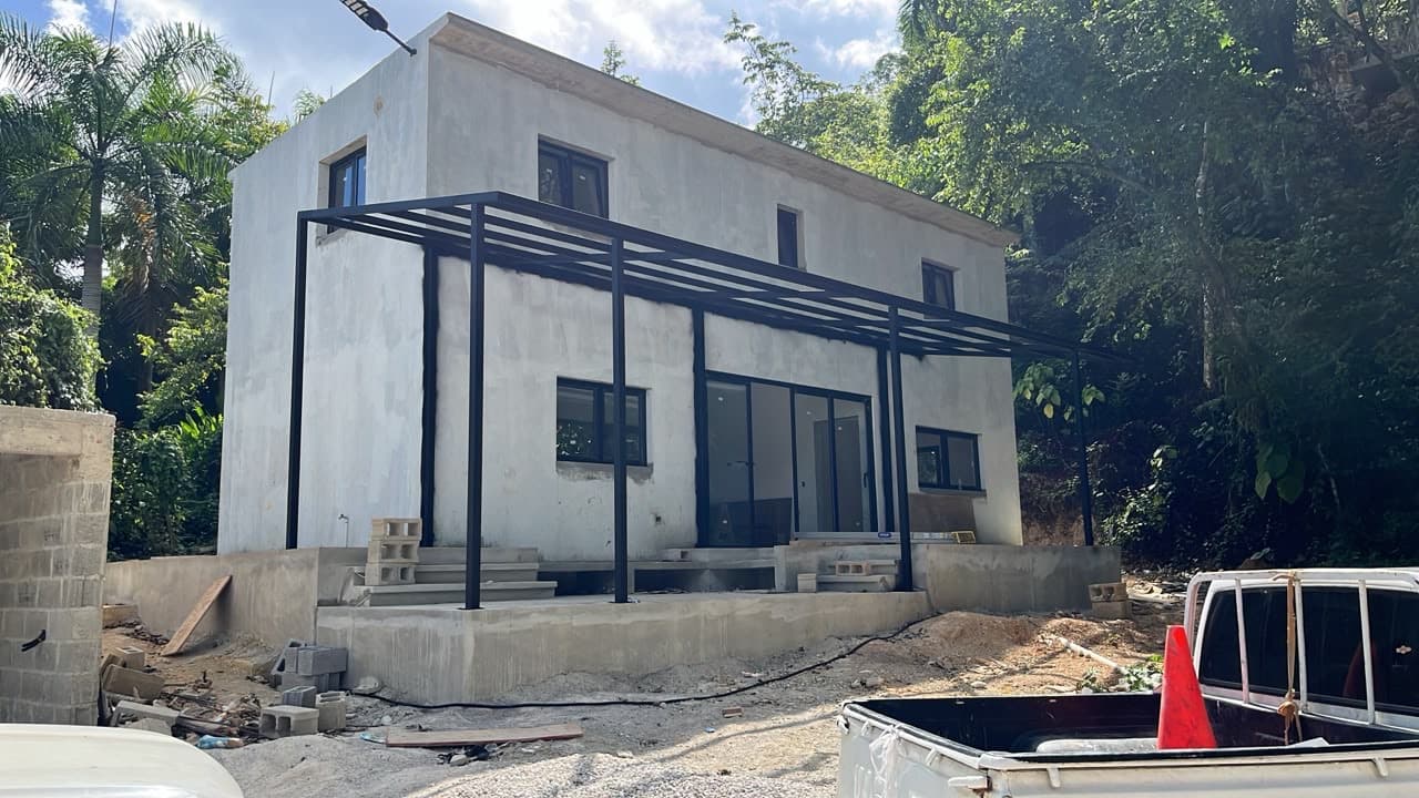 The first Samanea loft taking shape on the hillside, jungle behind it